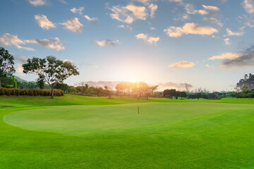 Beautiful view landscape in morning time green grass at golf course ,big trees, sand bunker and mist with sunlight rays background.