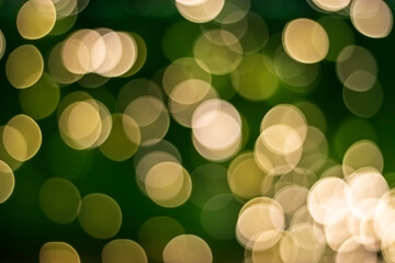 Bokeh. gold and green defocused lights on a dark green background. Spring background