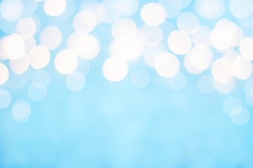 white defocused lights from above on a blue background, concept for design. Bokeh