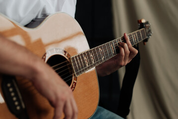 Fototapeta premium male hands and guitar close-up musician playing acoustic guitar