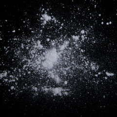 White powder explosion on black background.