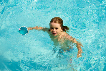 Kids in swimming pool. Children summer vacation. Summertime attractions concept. Swimmingpool.