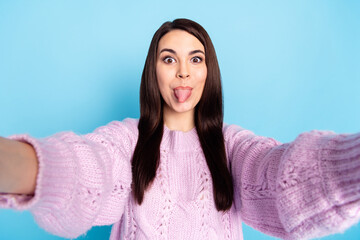 Photo of young woman happy positive joke fooling grimace tongue-out shooting selfie isolated over...