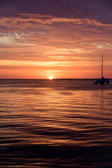 Sea boat on water. Sailboats at sunset. Ocean yacht sailing along water.