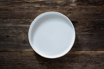 White empty dish on wooden background