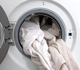 Washing machine filled with white laundry