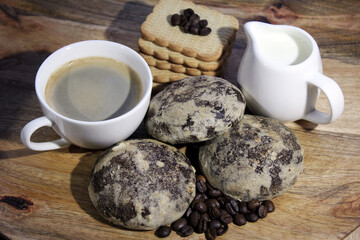 white cup americano with gingerbread and cookies on a wooden table. a cup with coffee and a cup with milk and cookies. breakfast with gingerbread and cookies.