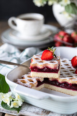 piece of delicious berry pie with strawberries with cup of coffee for breakfast. Vertical