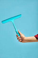 water draining instrument tool in hands of female, tools for household repair. isolated blue background