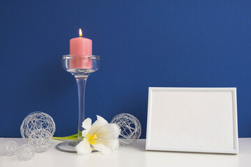 blossoming tulip, lit pink candle, white frame and metal balls