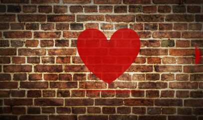 Heart symbol spray painted on the brick wall