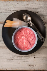 Still life about making homemade raspberry ice cream, top view, blue wooden table.