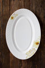 White empty dish on wooden background