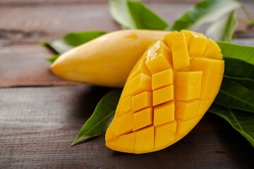 Tropical Fruits mango sliced with leaves mango on wooden. snack sweet food and summer fruits for good health.