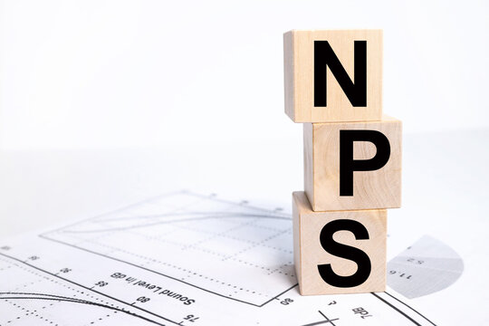NPS NET PROMOTER SCORE. text in black letters on wood blocks
