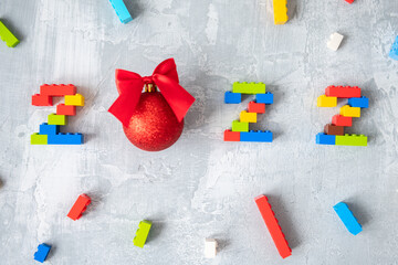 multicolored numbers 2022 from kids constructor set on isolated gray background with place for text