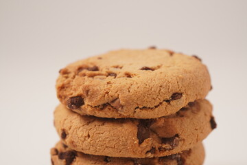 Delicious homemade vanilla flavor cookies with chocolate chips on white background