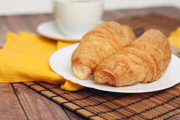 crispy fresh croissants on a plate on the table breakfast dessert