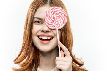 attractive woman covering face with candy candy emotion close-up