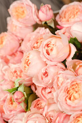 Many bright pink roses close up background.