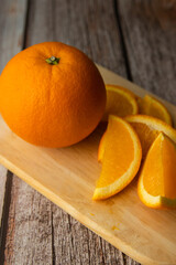 Beautiful Oranges Full and Sliced on old wooden backgroung. rich with vitamins.texture.