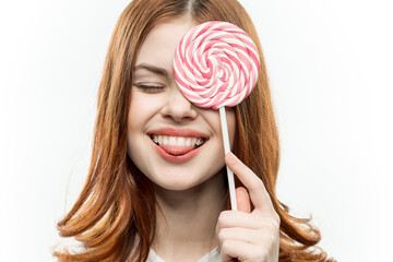 attractive woman covering face with candy candy emotion close-up