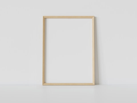 Wooden frame leaning on white floor in interior mockup. Template of a picture framed on a wall 3D rendering