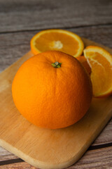 Beautiful Oranges Full and Sliced on old wooden backgroung. rich with vitamins.texture.