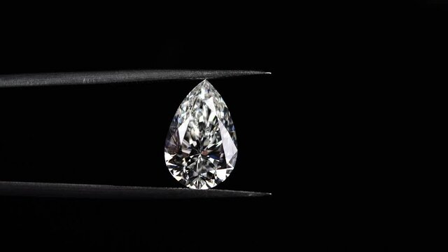 Moving pear shape diamond with tweezers 4k