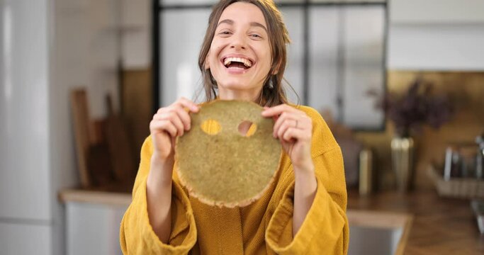 Happy woman cooking pancakes for breakfast