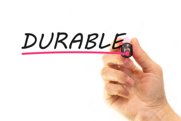 the hand writes the word durable with a marker on a white background. business concept