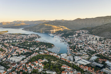 Fototapeta na wymiar Aerial drone shot of Lapad Dubrovnik bridge with sunrise over peak in Croatia summer morning