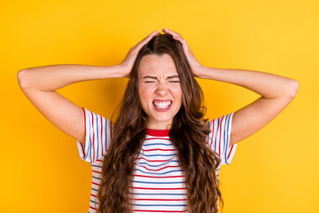 Photo of tired upset young lady dressed striped t-shirt headache arms head isolated yellow color background