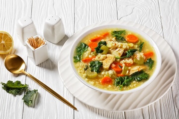 chicken kale veggies soup in a bowl