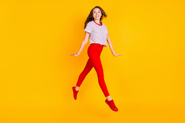 Fototapeta na wymiar Full body profile side photo of young excited girl happy positive smile have fun jump up isolated over yellow color background