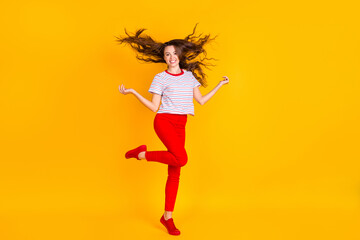 Fototapeta na wymiar Full length photo of young cheerful woman happy positive smile fly air hair isolated over yellow color background