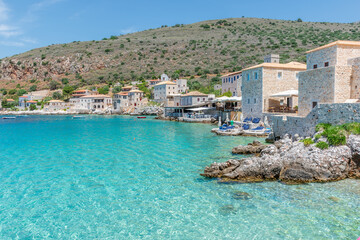 view of  Limeni village with fishing boats in  turquoise waters and the stone buildings as a...