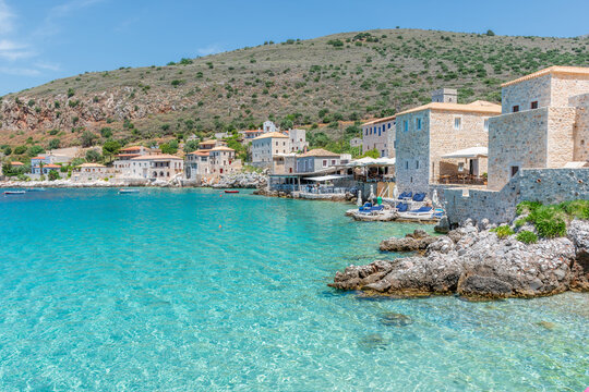 view of  Limeni village with fishing boats in  turquoise waters and the stone buildings as a background  in Mani, South Peloponnese , Greece.