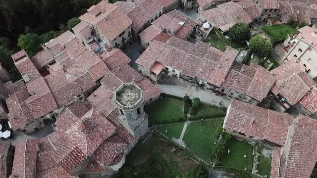Aerial Ascend: Tourists By Tower Amidst Structures In Town