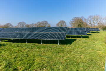 large array of solar panels on a solar farm in West Sussex England clean renewable energy