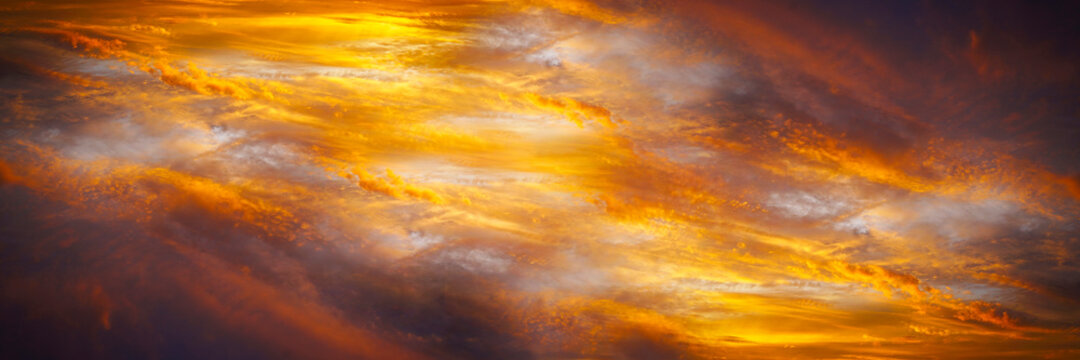 Fiery orange sunset. Fantastic dramatic sky background. Science fiction, fantasy, astrology, magic concept. Planet, galaxy, black hole, arocalypse, armageddon. Wide banner. Panorama.