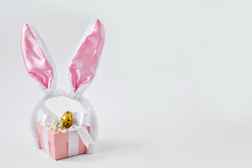 The minimal concept of Easter. An Easter card with a copy of the place for the text. Bunny ears and a gift box.