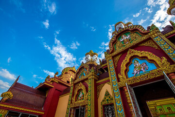 Naklejka premium Wat Mahathat Wachiramongkol Former name (Wat Bang Tong) is located Krabi,The environment is rubber plantation. And oil palm plantation, a towering pagoda is beautiful, tourists are always watching.