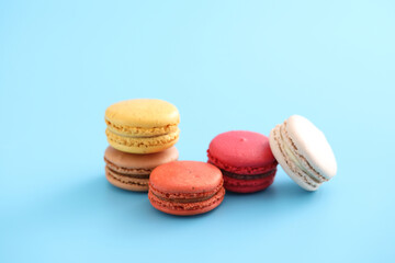 Colorful macarons isolated in blue background