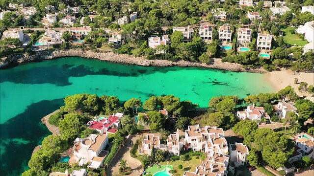 Mallorca, Spain: Aerial view of summer resort town Cala d'Or on Mallorca (Majorca), coast of island and clear waters of Mediterranean Sea - landscape panorama of Balearic Islands from above, Europe