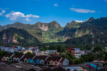 Fototapeta premium Blurred abstract background from high angle from plane window, overlooking the scenery below (river, mountain, tree).