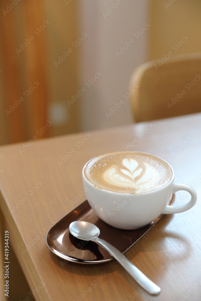 Wall mural cappuccino or latte art coffee made from milk on the wood table in coffee shop