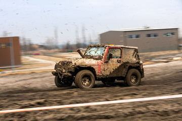 Dirty 4x4 vehicle starting in a off road competition. Dynamic shot of  car on  in the  off  road circuit race