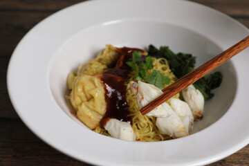 Shrimp dumpling noodles and crab meat on wood background