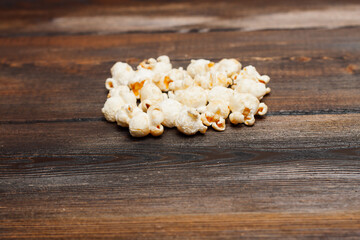 Fototapeta na wymiar popcorn on a wooden table snack classic delicacy
